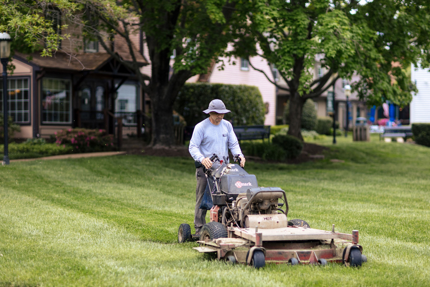 Landscaping professional mowing a lawn